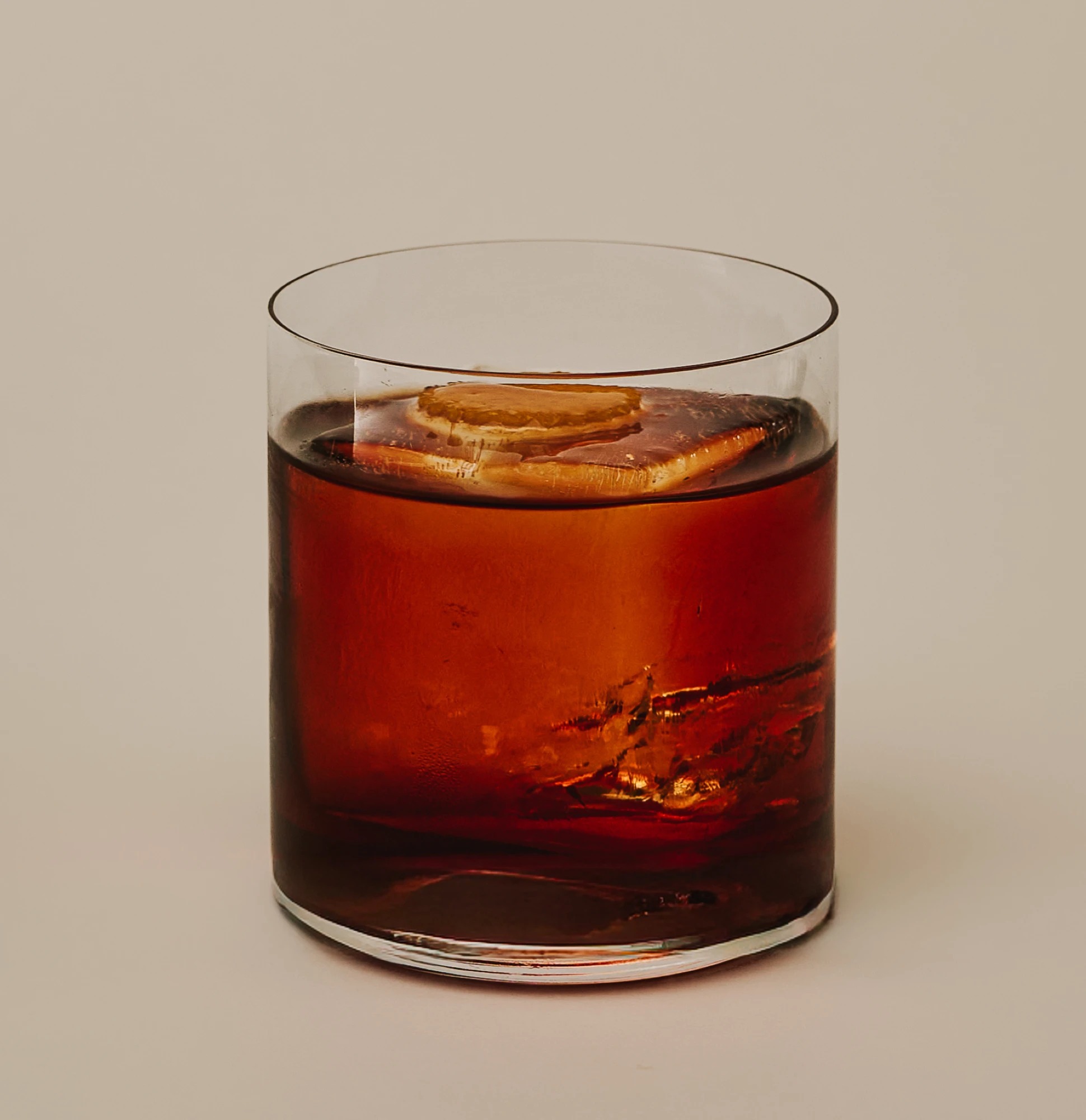 A Negroni served over ice with an orange slice