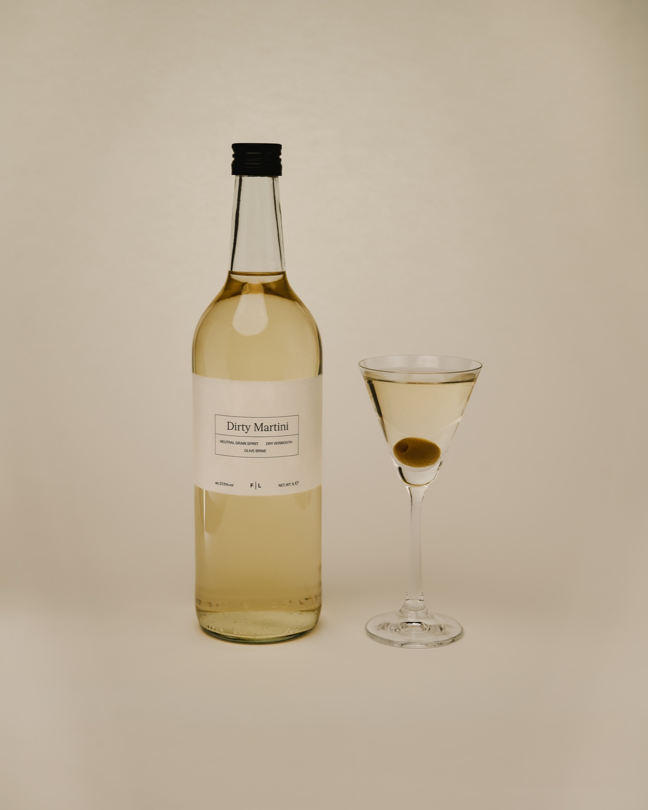 Bottled Dirty Martini with a poured martini glass