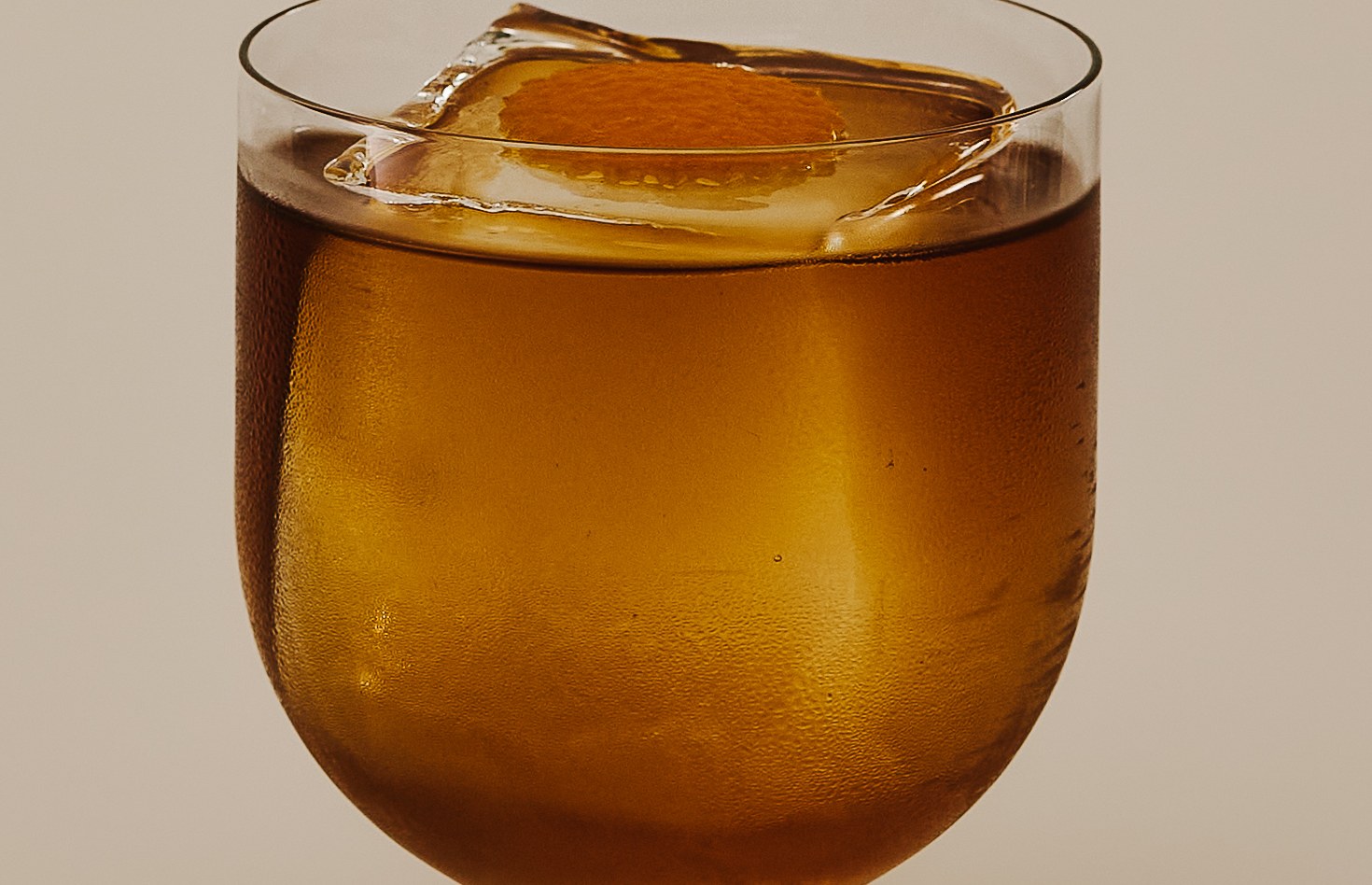 Close-up of an Old Fashioned over a large ice cube