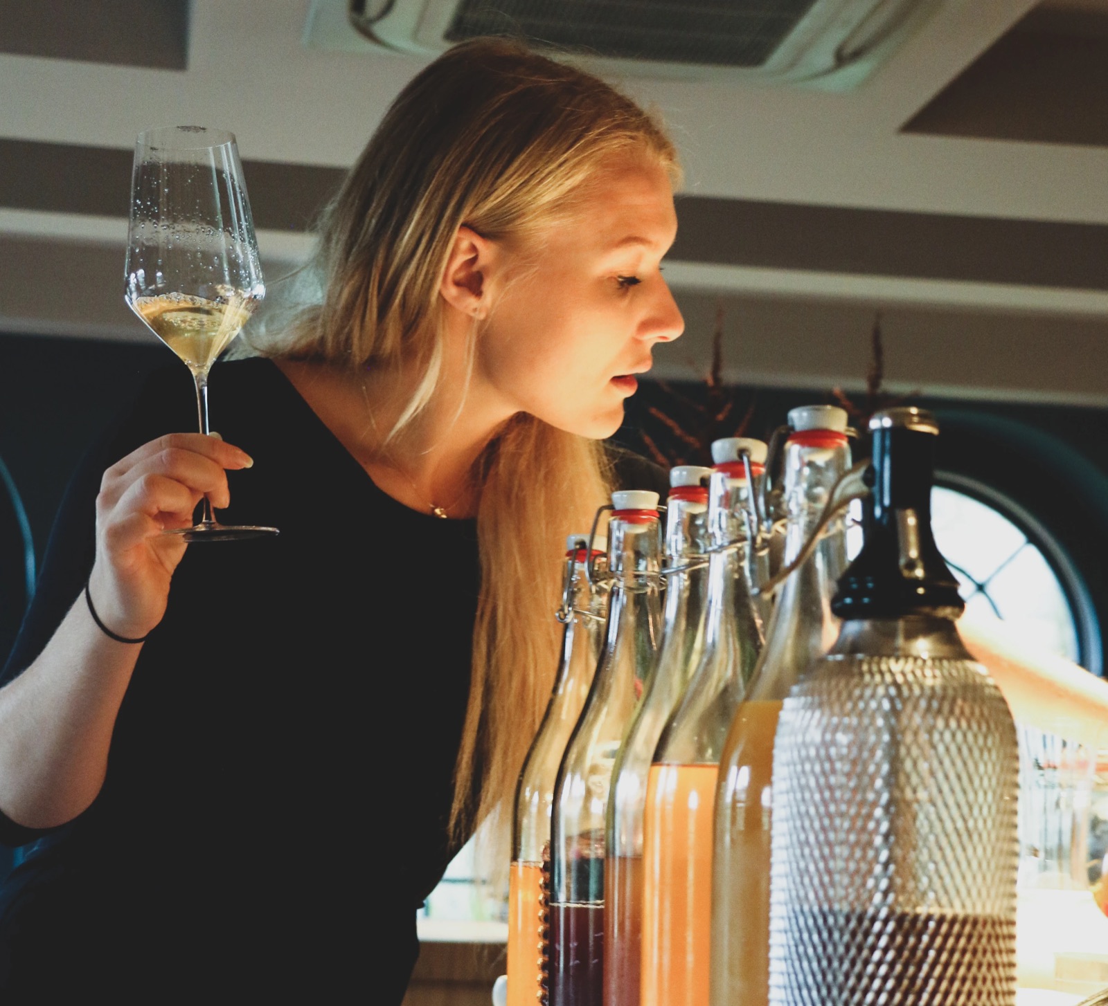 Majken Bech-Bailey examining a glass of wine
